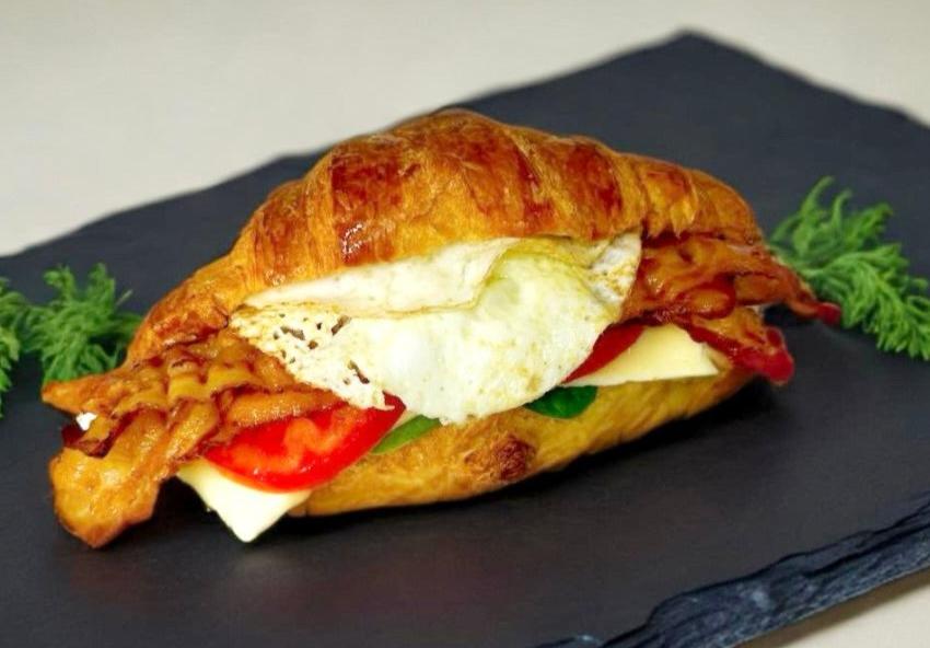 Fresh Croissant with Bacon, Egg White, Cheese, Tomato, and Spinach